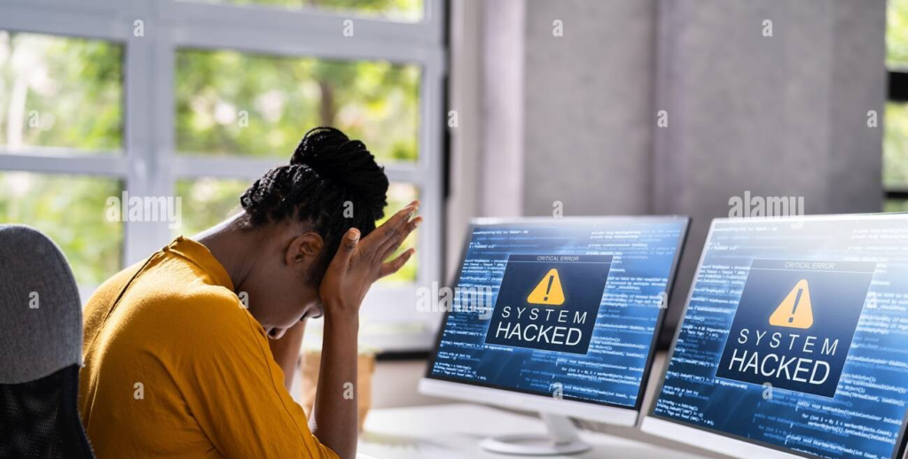 Business professionals looking concerned while reviewing cybersecurity risks on a laptop